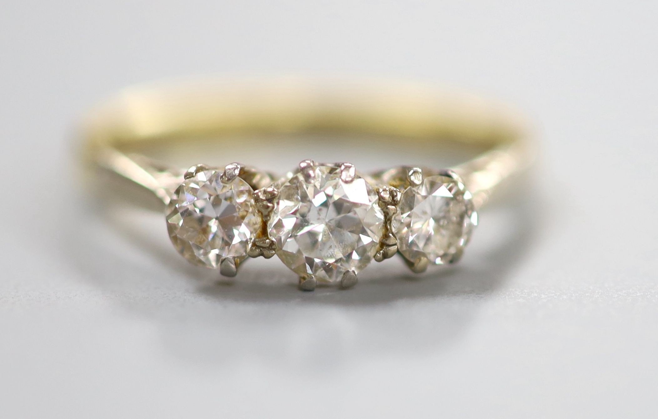 An 18ct & Pt, three stone diamond ring, size M, gross 2.4 grams.